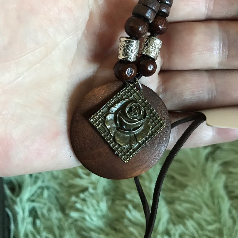 Wood and antique bronze rose emblazoned necklace.